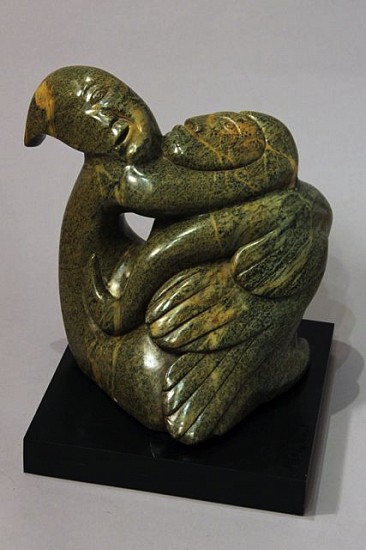 Abraham Anghik, Bird/sedna transformation
Brazilian soapstone,  (39.4 x 35.6 x 25.4 cm)
SOLD
This complex transformation is an excellent example of Abraham Anghik Ruben's artistry.   Sedna, the Inuit governing spirit of the sea and its creatures, is entwined around and merges with a large bird and another spirit, all executed in a beautiful green-brown stone.  Traditional Inuit believed that shamans could transform into other creatures, and many sculptures depict various stages of such transformations.  Abraham Anghik Ruben was born in Paulatuk, but as a child was sent south to a state school.  As an adult, he settled near Vancouver, and carves imported Brazilian soapstone.  He has worked to reconnect, through his art, with traditional Inuit beliefs and images. His work was showcased in a recent single-artist exhibit by the Smithsonian Institution National Museum of the American Indian.
01210-1