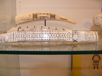 19th & 20th C Alaskan Anonymous -&nbsp;Cribbage board depicting rain or shine faces