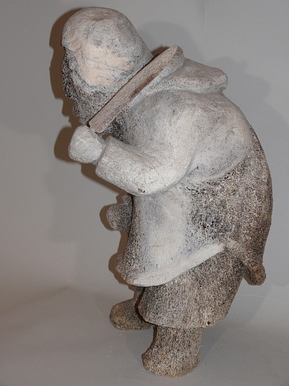 Inuit Anonymous, Large whalebone woman with knife
22 x 9 x 14 in.
Like the narwhal, this woman carved in whalebone defies the usual limitations of the medium.  The subtle curve of the amauti's hood, and the undercut and graceful hem of the amauti bespeak a master carver's touch.
03708-1