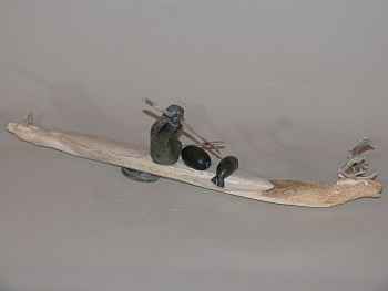 Pauli - Hunter in kayak with caribou swimming ahead and astern